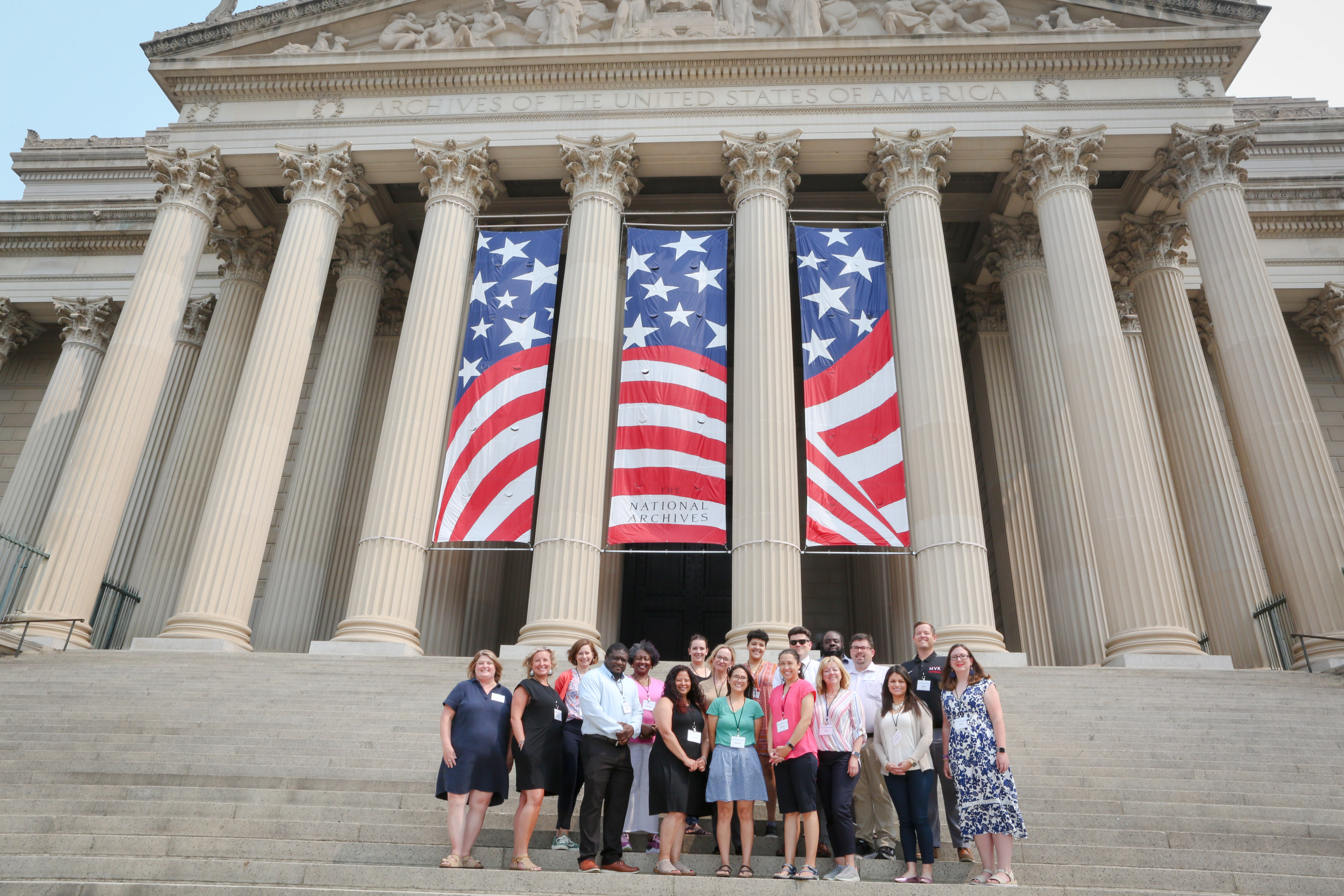 Civics for All of US Teacher Institute attendees pose on the steps of the National Archives Building in Washington, DC.